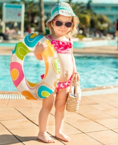 little cute girl near the pool with a circle for swimming